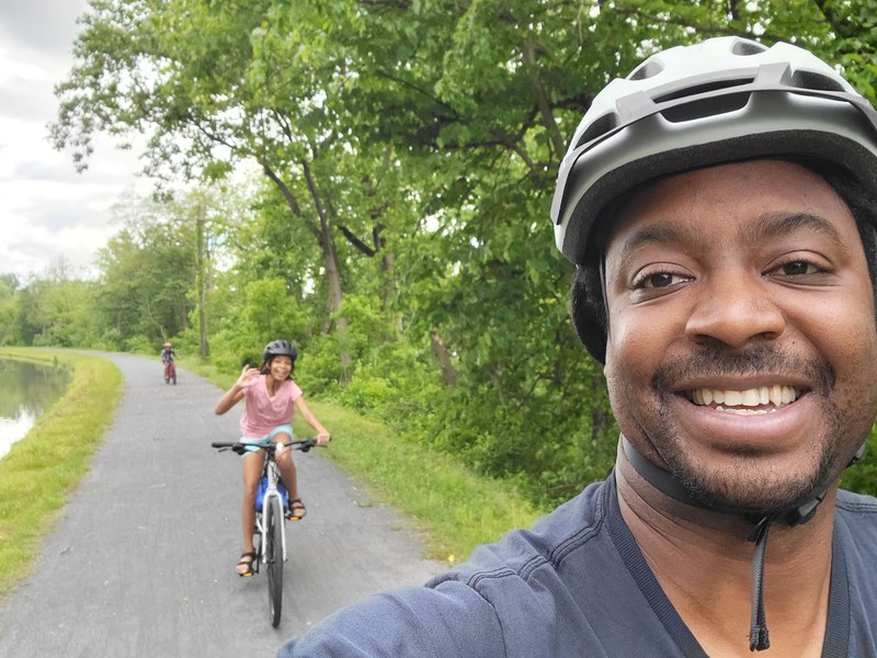 Jaquan on the Delaware and Raritan Canal towpath with his daughter riding behind